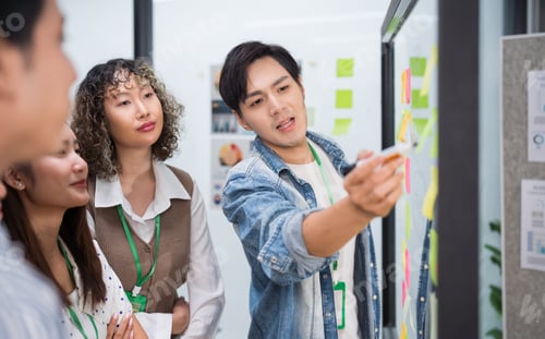 Preview: Group of young Asian business people team meeting in modern office working