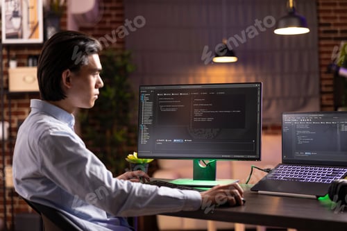 Preview: Self employed man working on html codes on multiple screens
