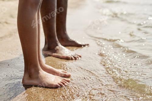 Preview: Dad and child standing on the beach