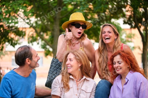 Preview: Five mature adults having fun in a park.