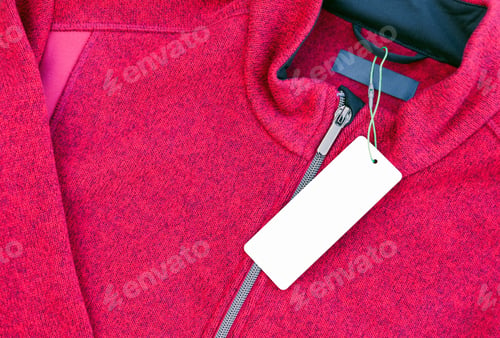 Preview: Blank clothing label tag on a red jacket