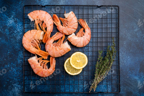 Preview: Ready for cooking Headless Red shrimps, raw Prawns on a rack. blue background. top view