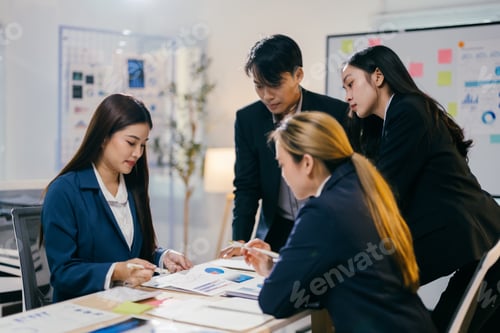 Preview: Team of asian businesspeople are working together in the office, using data and graphs to develop ne
