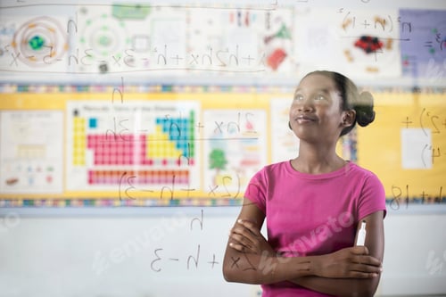 Preview: A student writing formula and equations on a clear perspex board, with pens.