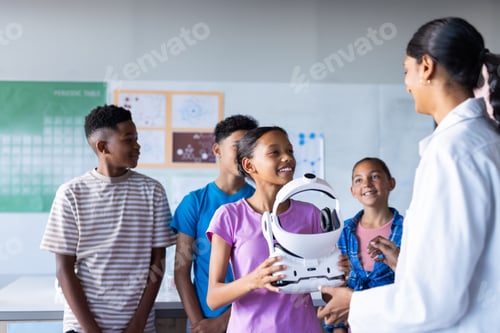 Vorschau: In der Schule interagieren Schüler mit einer indischen Lehrerin, während sie im Klassenzimmer ein VR-Headset in der Hand halten