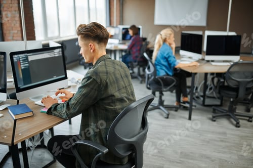 Preview: IT specialists group works at the tables in office