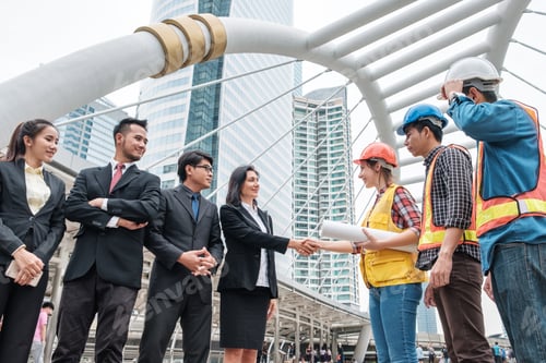 Preview: Multiethnic group of engineers and businessperson handshake with contract agreement
