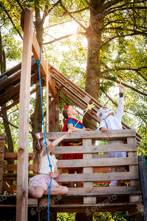 Preview: Three kids with superheroes costumes playing on their tree house