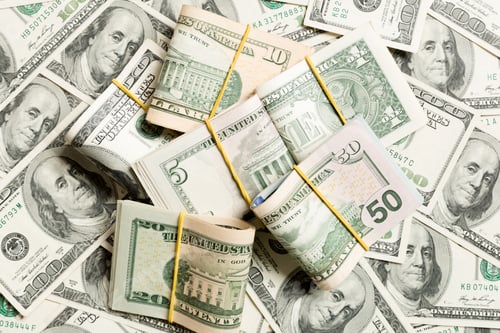 Preview: Stacks of one hundred dollars banknotes close-up on dollar background