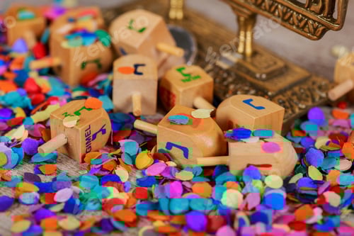 Preview: Wooden dreidel for Hanukkah on light background Hanukkah with wooden dreidel