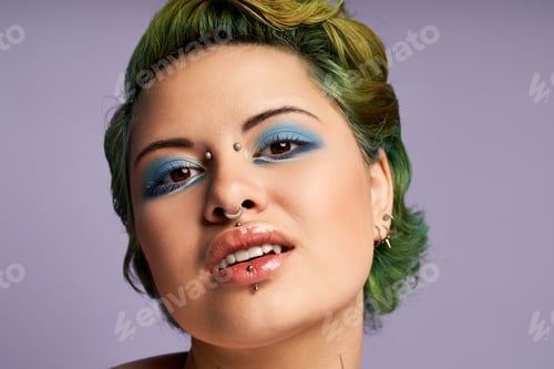 Preview: Vibrant young woman showcases bold fashion and artistic makeup against soft purple backdrop