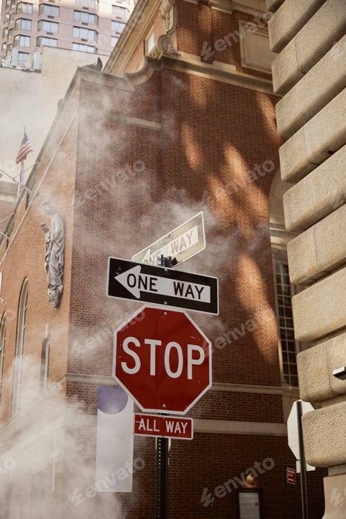 Preview: road signs near steam and vintage buildings on street of new york city, urban environment scene
