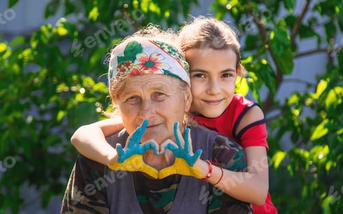 Preview: Child and grandmother hand drawn flag of Ukraine. Selective focus.