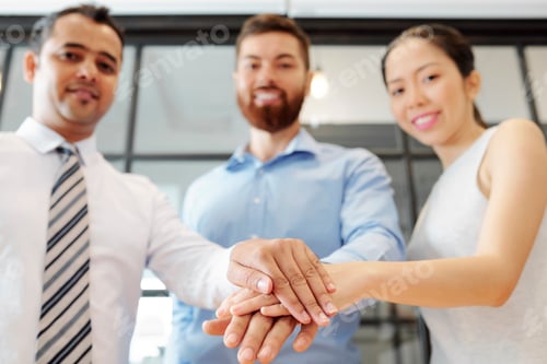 Preview: Business team stacking hands