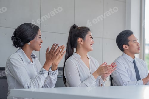 Preview: business people applauding in a meeting room or seminar