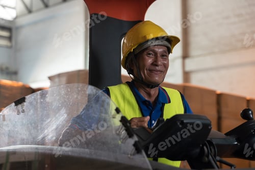 Preview: Portrait of happy asian old man working in warehouse and sitting on forklift
