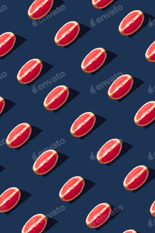 Preview: Flat lay pattern with summer grapefruit fruit on blue background. Minimal concept with sharp shadows