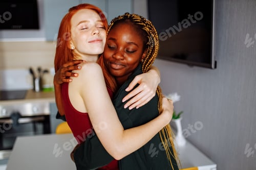 Preview: Multiracial couple girlfriends in love embracing in room