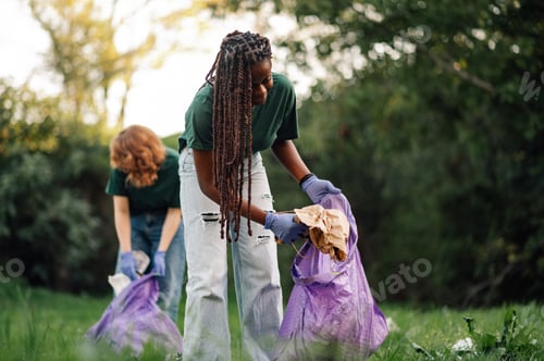 Preview: Volunteers collecting garbage in public park wearing gloves