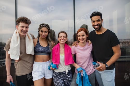 Preview: Young people standing after exercise outdoors on terrace, sport and healthy lifestyle concept.