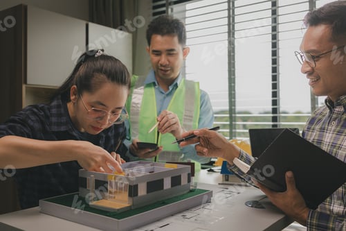 Preview: A team of engineers meets in the office to analyze the design structure to ensure it meets the clien