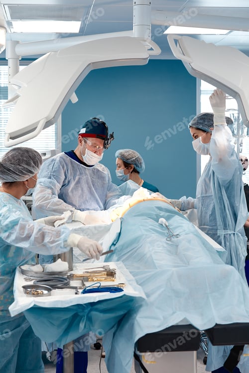 Preview: Doctor and surgeon assistant send manual surgical instrument to rescue patient in operating room in