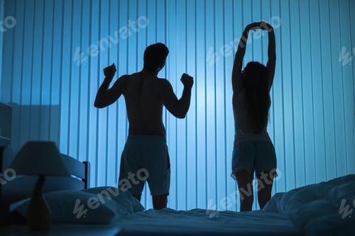 Preview: The couple doing exercise near the bed. night time