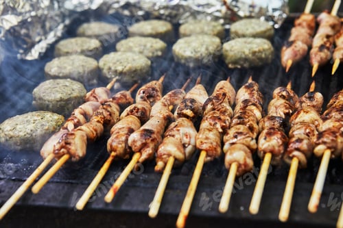 Preview: BBQ burgers, grilled hearts on skewers and smoke barbecue party. Close-up