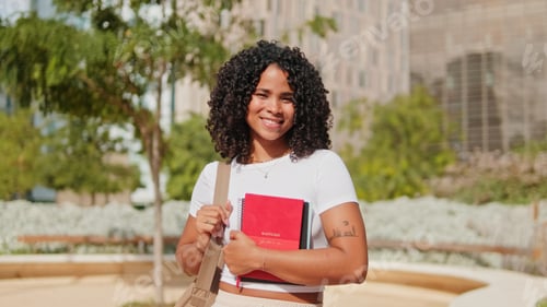 Preview: Happy Student On Campus With Books