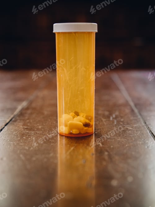 Preview: Drugs, pills, medicine in a plastic container on an old wooden table