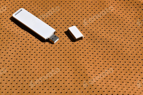 Preview: A modern portable USB wi-fi adapter is placed on the orange sportswear made of polyester nylon fiber