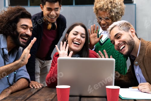 Preview: Smiling multiracial group of friends on a video call waving hand saying hello to friend