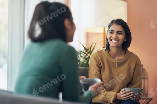 Preview: Woman Chatting with a Friend over Coffee Indoors