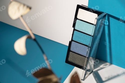 Preview: soft blue eyeshadow palette on geometric background.