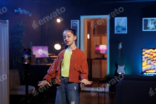 Preview: Girl dancing and singing while shooting video with cellphone on tripod stabilizer for social media