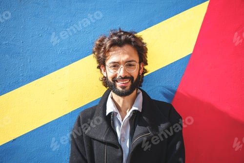 Preview: Cheerful man near colorful wall