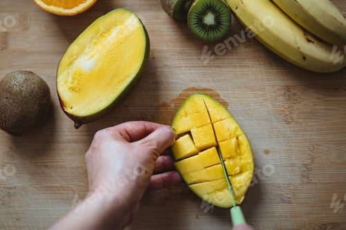 Preview: A woman cutting a mango.