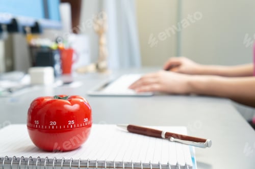 Preview: Closeup shot of an organized desk with a person working on the computer