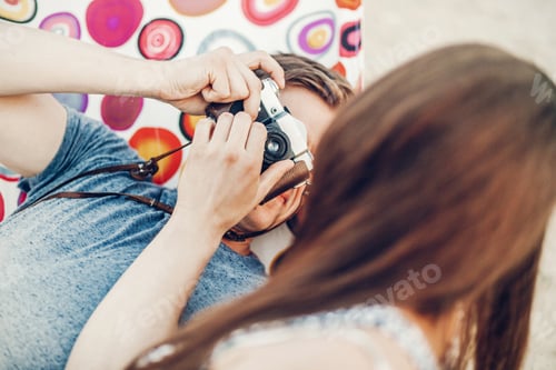 Preview: Handsome man taking picture of a beautiful brunette girl