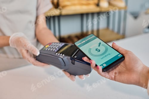 Preview: Bakery employee getting payment from customer