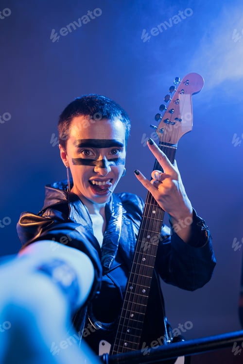 Preview: Punk rocker sticking tongue out doing rock sign