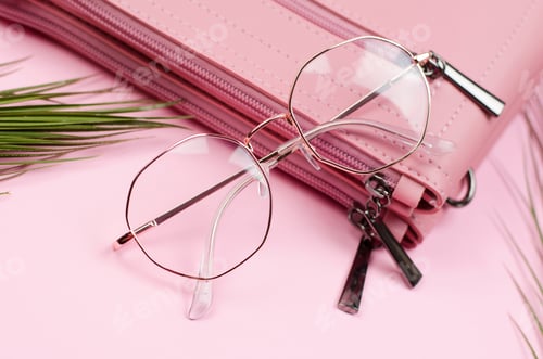 Preview: Stylish eyeglasses on a pink women's handbag, close-up