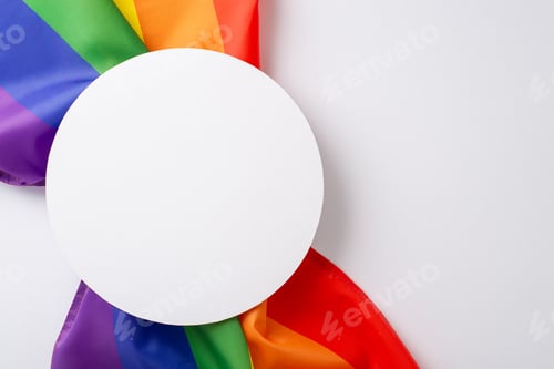 Preview: Standing together for equality: A rainbow flag, viewed from above on a white surface