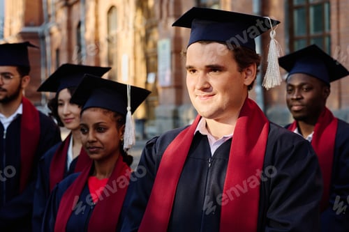 Preview: Group of graduated students standing outdoors
