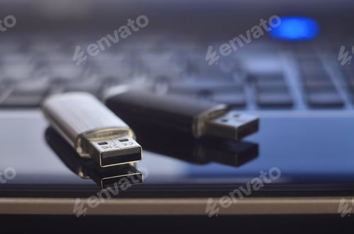 Preview: USB flash cards lying on black laptop case in front of his keyboard