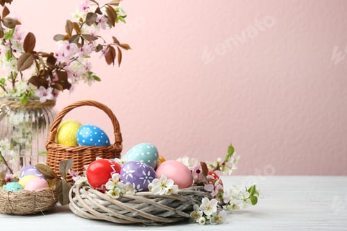 Preview: Composition with painted Easter eggs and blossoming branches on table. Space for text