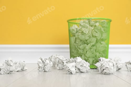 Preview: Metal bin with crumpled paper against color wall, space for text