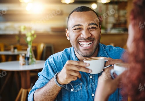 Preview: Cropped shot of a handsome young man spending time with his girlfriend in a coffee shop