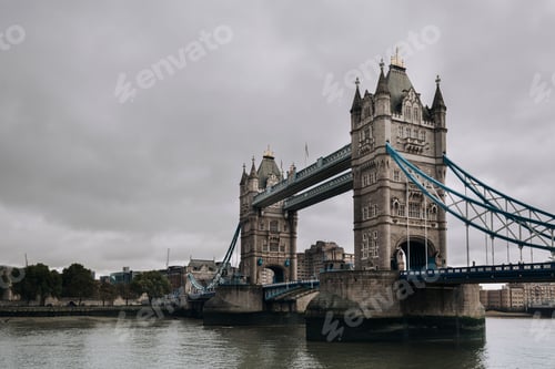 Preview: Low angle shot of the Tower Bridge in London over the River Thames in cloudy weather