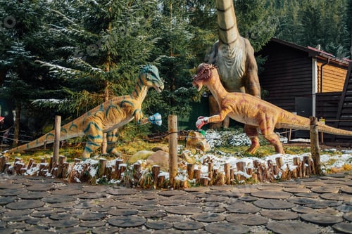 Preview: Bukovel, Ukraine - December 2023. Attraction statue of dinosaurs model in Dinopark